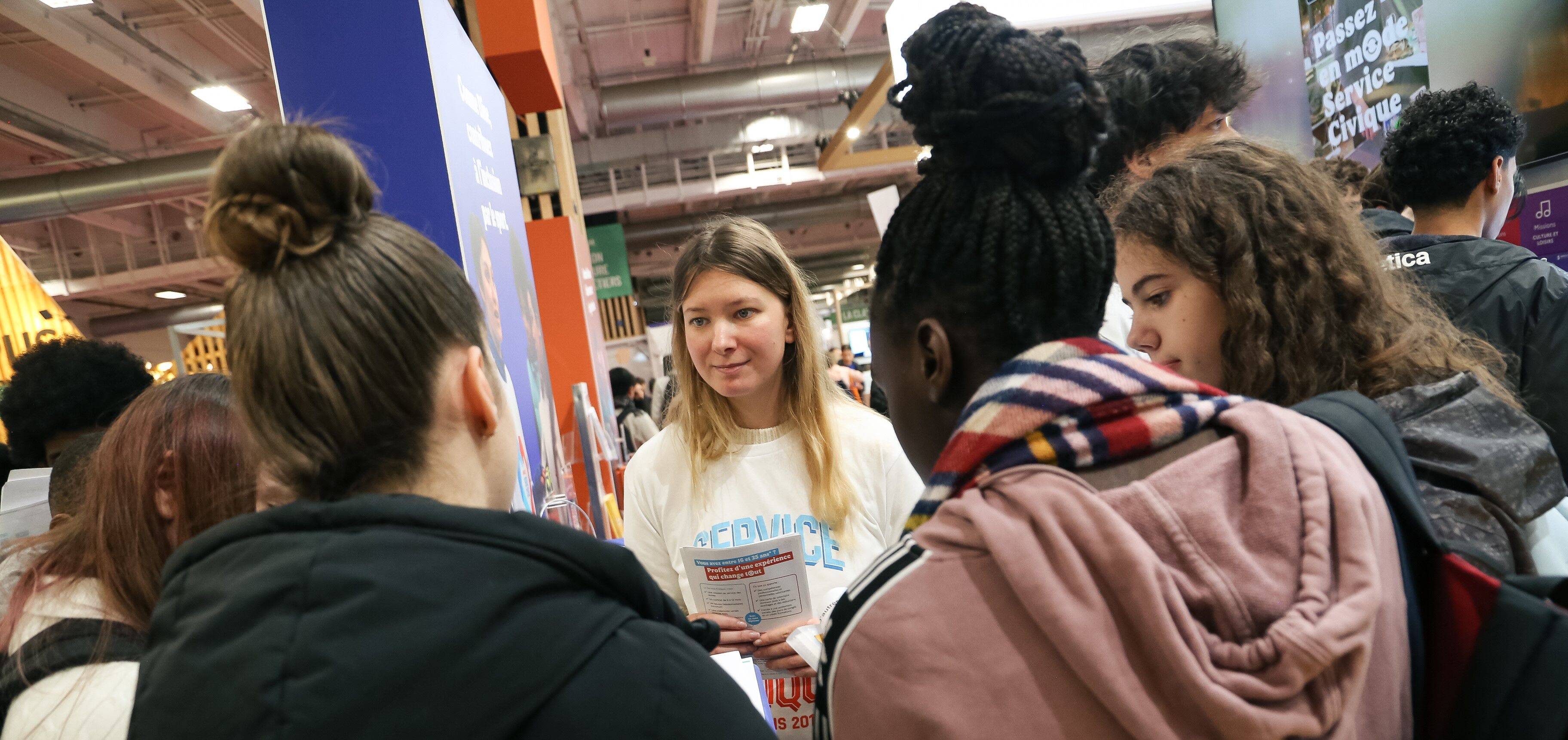 Une volontaire en Service Civique renseigne des jeunes